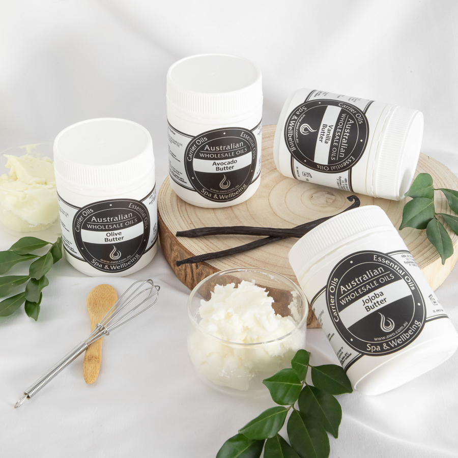 Four skincare jars on a wooden surface with greenery and flowers.