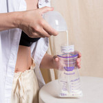 Close up of 8oz click-tight cup with easy-pour spout showing milk collection