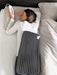 Beurer extra large heating pad being used on back – soft fabric provides cozy warmth for muscle tension relief