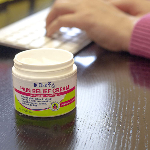 Applying TriDerma pain cream to sore knee – non-greasy texture providing long-lasting comfort without burning or irritation