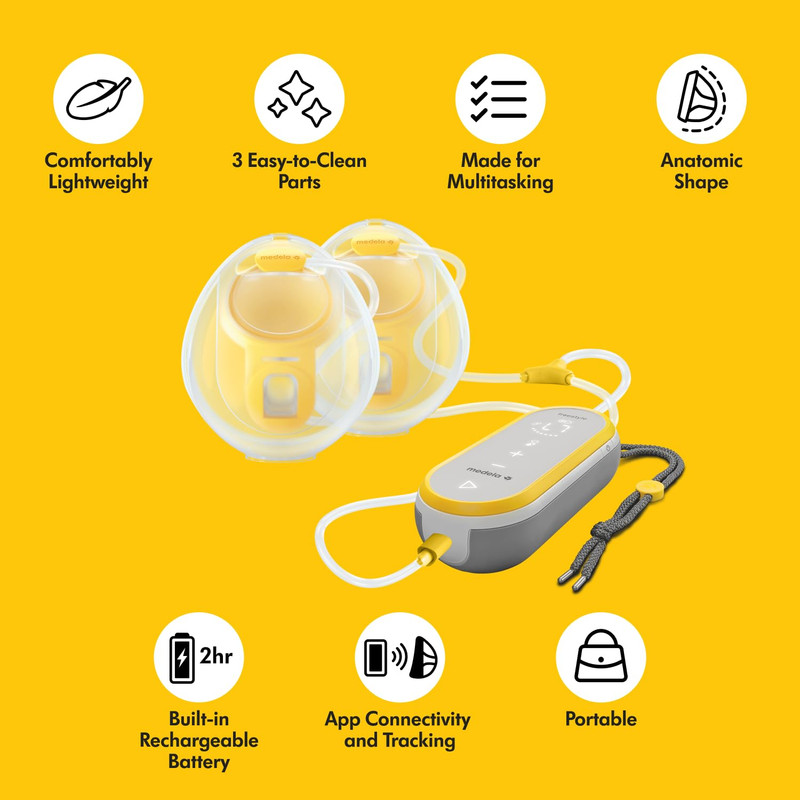 Mother using Medela Freestyle Hands-Free with collection cups discreetly inside bra while working on laptop