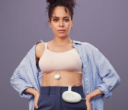 Elvie Stride fitting discreetly inside standard nursing bra for hands-free pumping