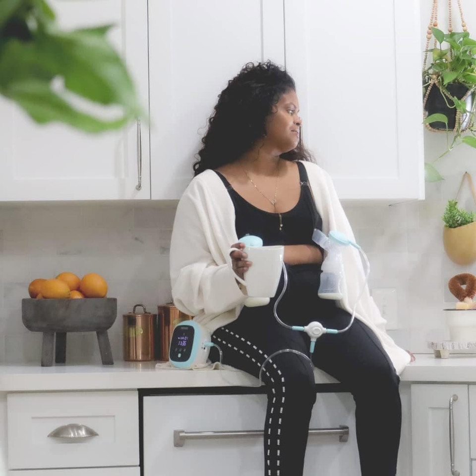 Zomee Z1 double electric breast pump in use – closed system technology prevents milk from entering tubes
