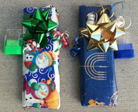 Gift Wrap Paper includes three colored ribbons, a gift bow and a small, plastic pencil sharpener. Available in four styles: Chanukah themed, Christmas themed, winter themed and solid color. Shown are examples.