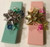 Two sturdy gift boxes with a pad of soft cotton on the inside hold 1-2 dozen personalized pencils.  Includes a three colored ribbon and gift bow.  Available in light blue or light pink.