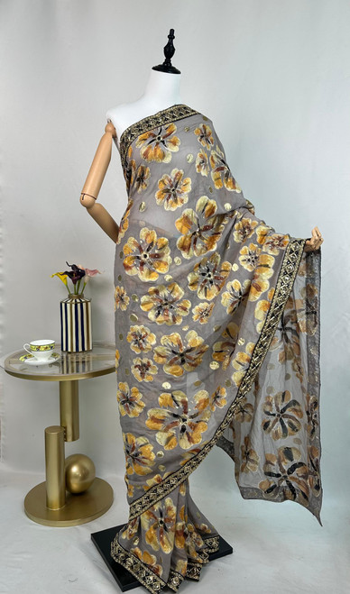 Luxe Grey Organza Saree with Handpainted Golden Floral Motifs & Embroidered Border Luxe Grey Organza Saree with Handpainted Golden Floral Motifs & Embroidered Border