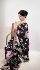Elegant Black Floral Print Saree with Ornate Gold Border