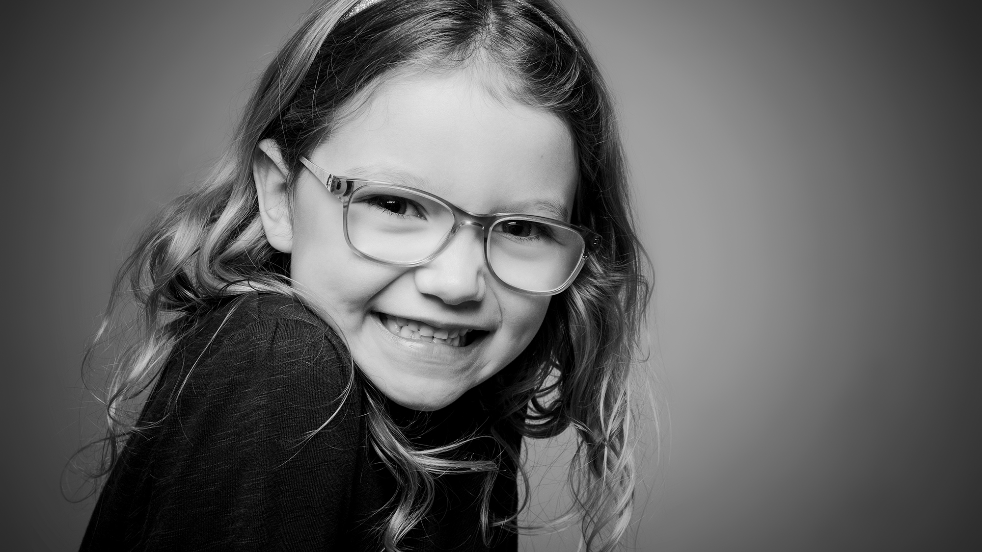 Black and White picture of a little girl smiling