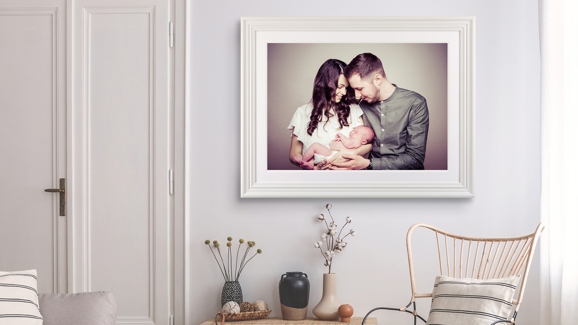 newborn family picture framed in a home by Emotion Studios photography