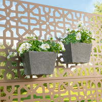 Two gray wall pots with white flowers mounted to outdoor decor