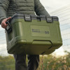 RidgeMonkey CoolaBox Compact being carried by a man from the handles 