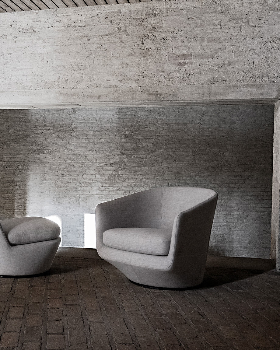 U Turn Chair and ottoman in a moody industrial setting.
