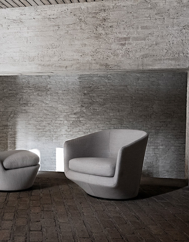 U Turn Chair and ottoman in a moody industrial setting.