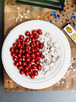 The image shows a plate of red velvet bites and s'mores bark. The plate is placed on a table indoors.
