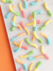 The image likely shows a shape or design made with candy or confectionery items, possibly in the form of a worm. The tags indicate that it involves food, snacks, food coloring, and dessert, emphasizing its sweetness.