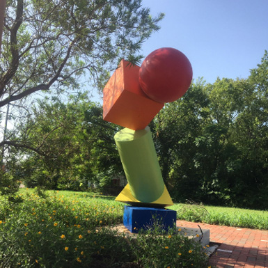 Colorful geometric outdoor sculpture in a garden