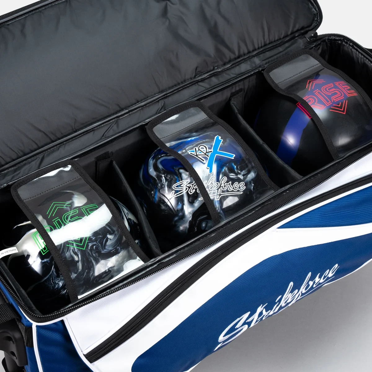 Three bowling balls in padded dividers inside KR Strikeforce Drive Dually triple roller