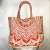 Vibrant red, yellow and orange mandala pattern cotton tote bag, with two straps.