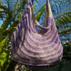 Natural fibre and dyed Bilum bag with a striped purple and natural pattern.