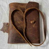 showing the strap closure of the vintage style soft covered leather note book.