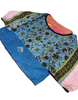 had stitched a vintage cotton kantha in blue, turquoise, black, and pink over a head shirt without buttons.