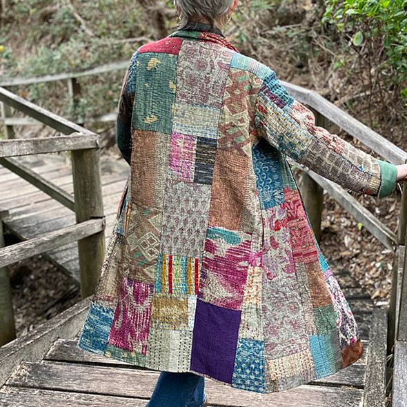 Showing the patchwork cotton kimono made from dusty toned kantha stitched squares. 