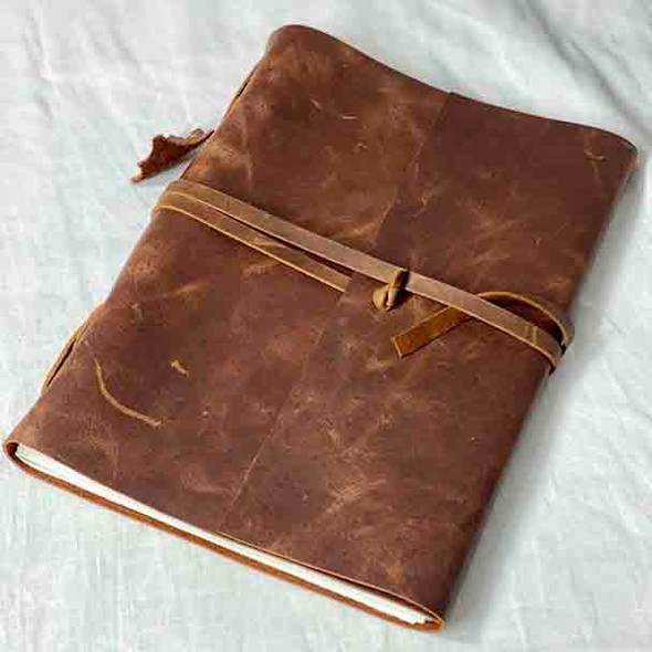 Showing the large A4 size leather medieval style journal.
