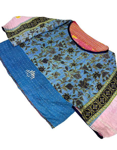 had stitched a vintage cotton kantha in blue, turquoise, black, and pink over a head shirt without buttons.