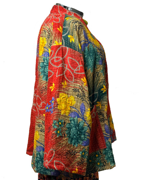 Running our hand over our floral swing coat allows you to feel the straight stitching, known as kantha stitch. White cotton threads in straight lines hold layers of soft cotton together to create a soft quilted jacket.