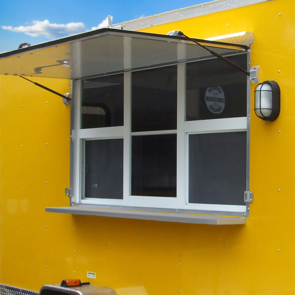 Aluminum drop down concession shelf installed on a yellow trailer.