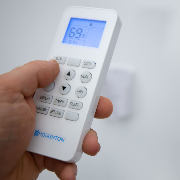 Hand Holding RV Air Conditioner Remote.
