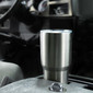 Stainless steel 30 ounce vacuum tumbler sitting in a car.