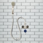 Showermiser installed in a shower with a brushed nickel shower head and hose.