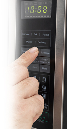 finger pressing the microwave button options