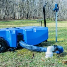 portable water tank with flex spout hooked up to dumping station