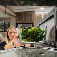 bowl of broccoli being microwaved