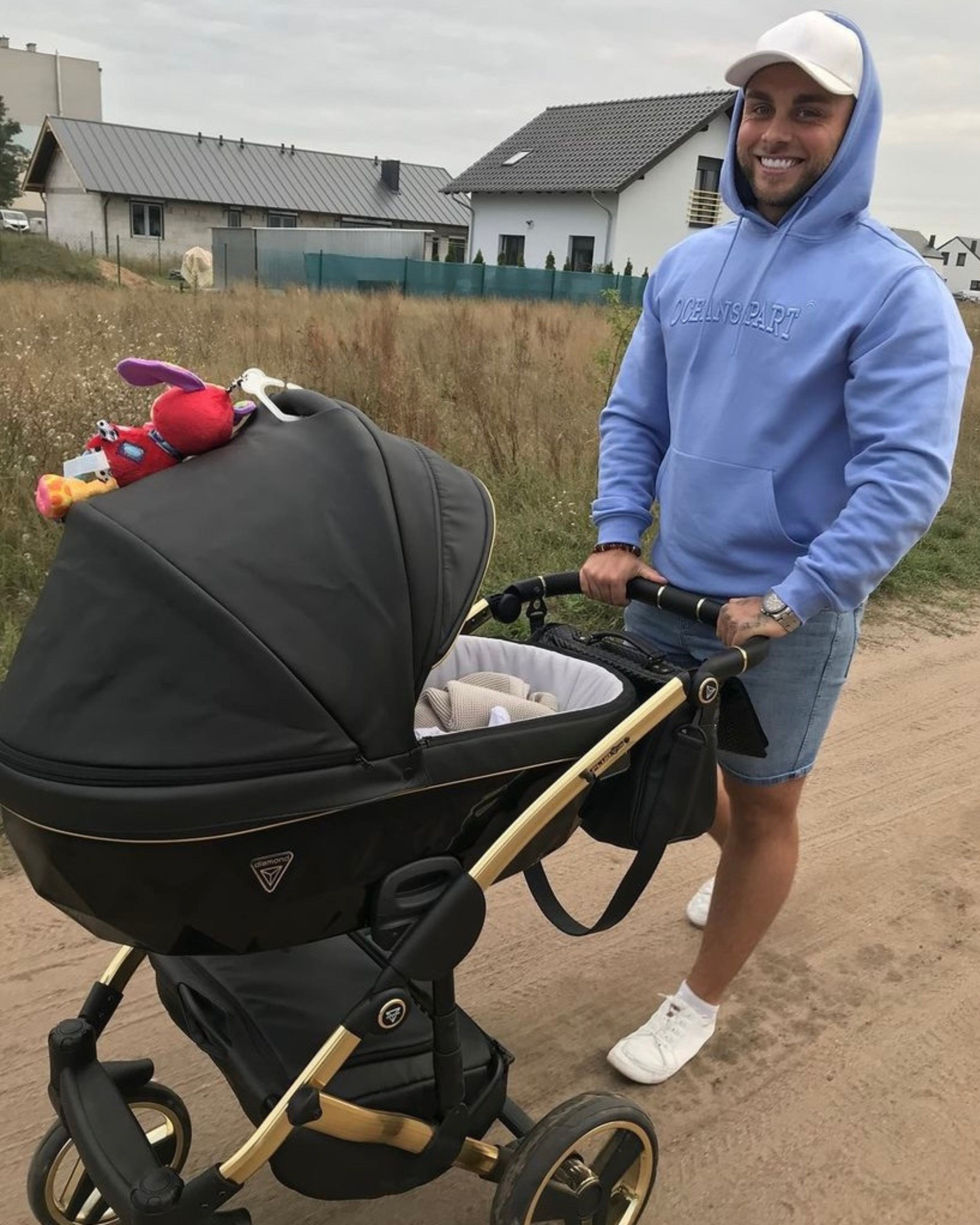 Junama Fluo Line Black Gold 2-in-1 pram with dad standing behind baby pram