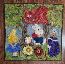 I designed and punched this magical Alice’s Wonderland as a class to teach creative ways to add texture and pizzazz to punch needle rugs.  With a spirit of experimentation and creative license I used 3 different sizes of Oxford regular point rug punches, needle felting tools, proddy tools, novelty yarns, wool yarns, fibers, silks, buttons, baubles, and linen as the foundation fabric.