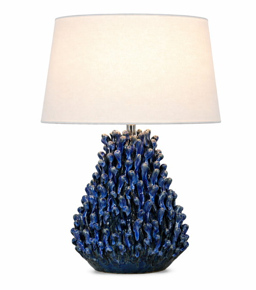 Handmade Thai blue anemone ceramic table lamp with deep blue textured base and white linen shade on a white background.