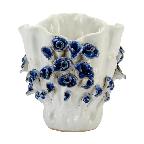Small blue and white floral ceramic vase with dimensional cobalt-blue rosette detailing on white background.