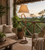 Prefer a room view beside a sofa, lounge chair, or in a corner where the lamp's curved silhouette is clearly visible.