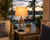 Mariner’s Knot rope table lamp L125 styled in a warm coastal interior with its sculptural knotted rope base clearly visible.