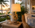 Nautical Knotted rope table lamp L128S styled in a tropical lanai with its prominent center knot and natural shade clearly visible.