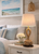 Monkey’s Fist natural rope table lamp L129 styled on a bedside table in a bright coastal bedroom.