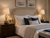 Monkey’s Fist rope table lamp L129 styled beside a bed in an upscale coastal bedroom with warm ambient lighting.