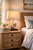 Anchor natural rope table lamp L138 styled on a bedside table in a light coastal bedroom setting.