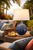 Deep blue Luna sea anemone ceramic table lamp displayed in an upscale coastal living room