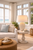 White coral sea anemone ceramic table lamp displayed on a side table in a bright upscale coastal interior