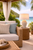Handmade Thai white ceramic sea anemone table lamp styled beside a sofa in a warm coastal living room