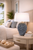 Blue sea anemone ceramic table lamp displayed on a side table in a bright upscale coastal living room